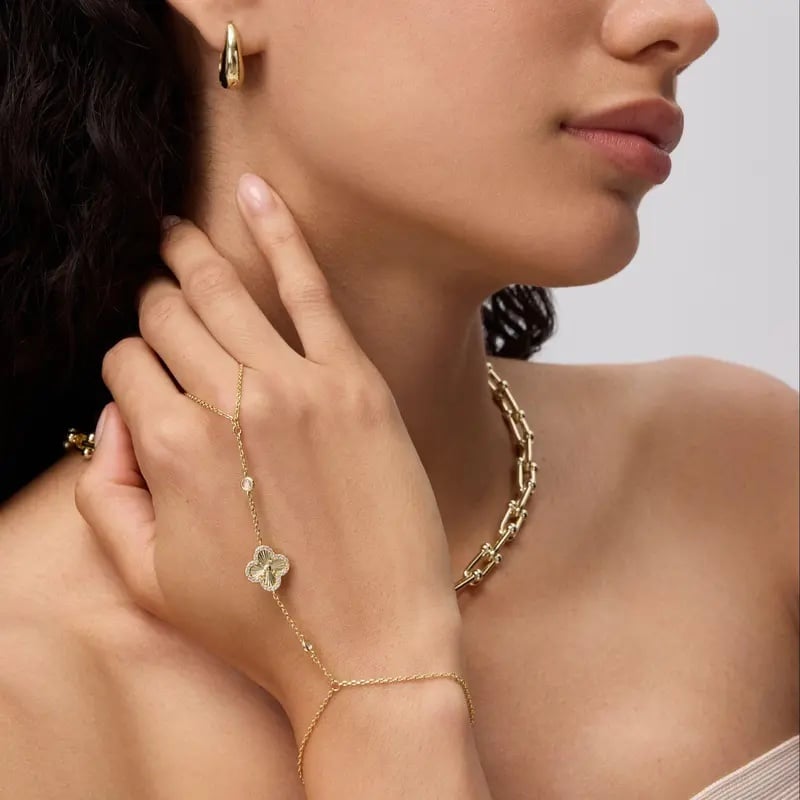 Women wearing gold hand chain jewelry