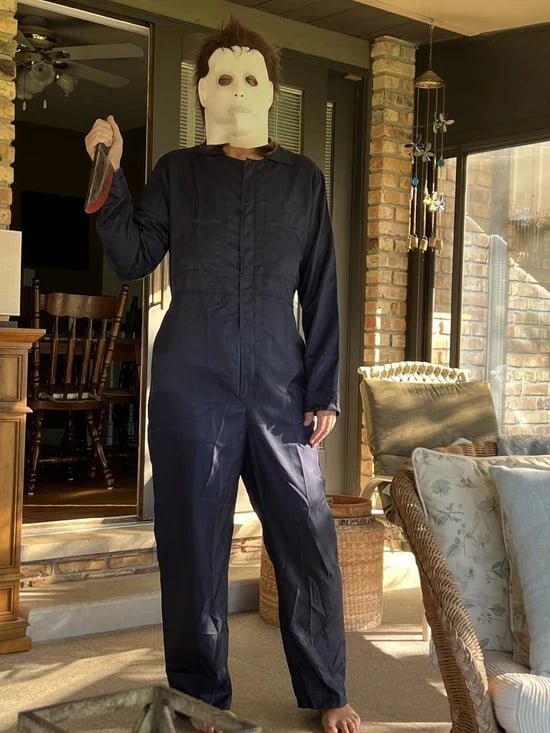 Costume fan in a full dark outfit and character mask