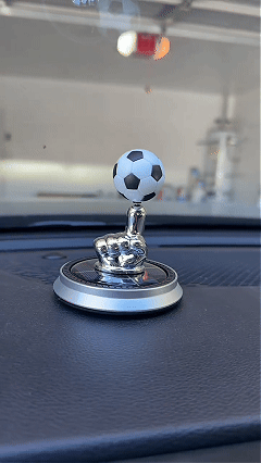 Soccer ball ornament spinning under sunlight