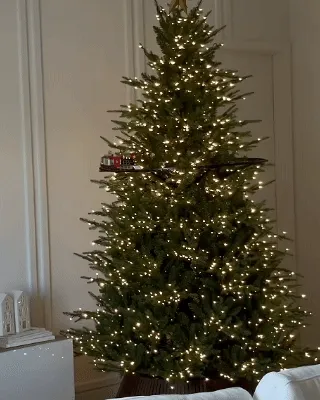 Christmas train on an elevated circular track around a decorated tree